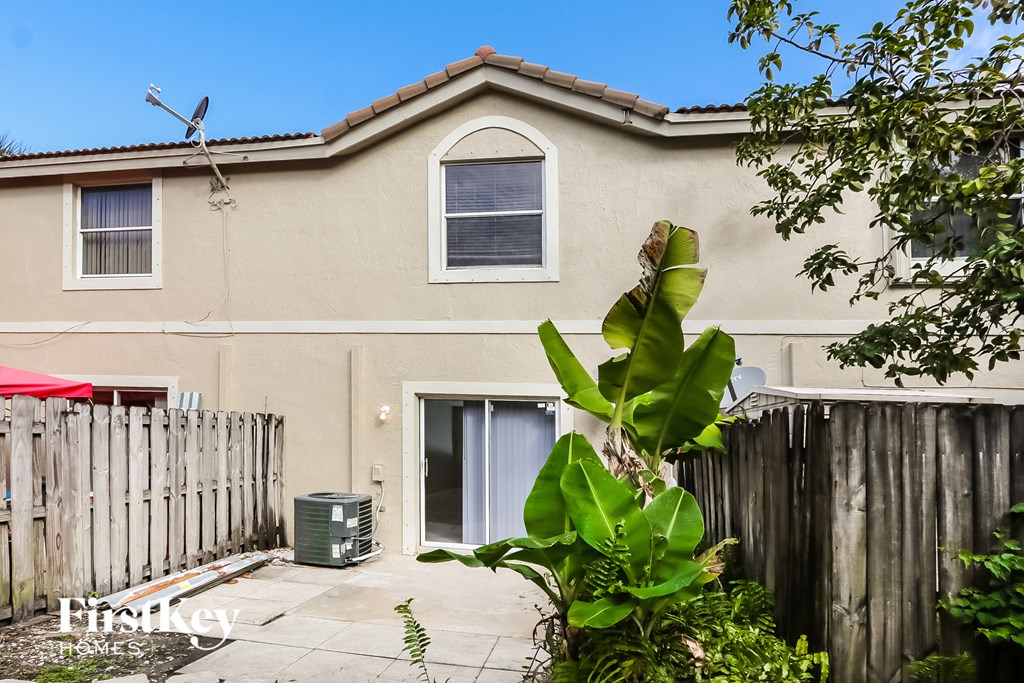 a house with a yard and a fence and a window