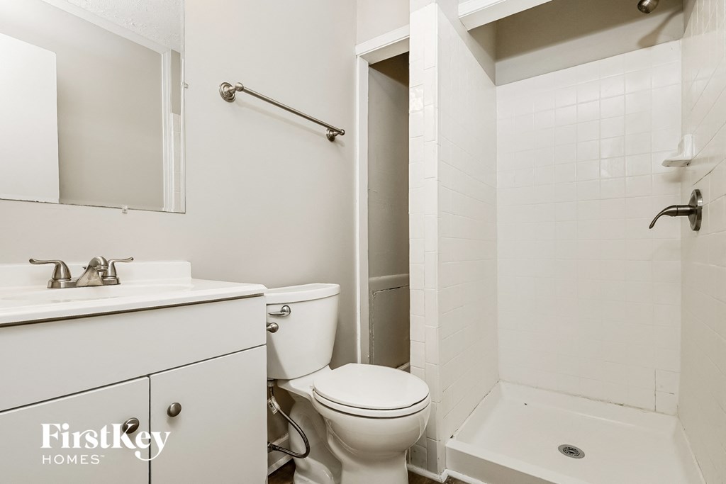 a white bathroom with a toilet and a tub and a sink