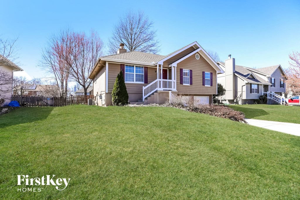 a home on the top of a hill with a lawn