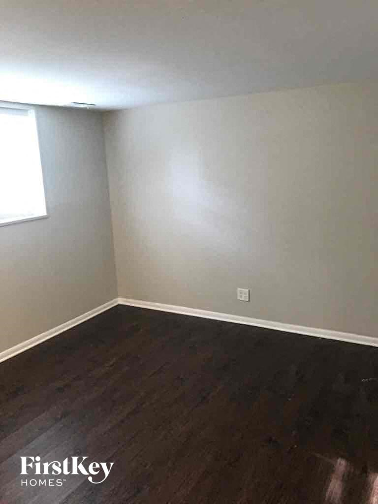 a empty room with wooden floors and a window