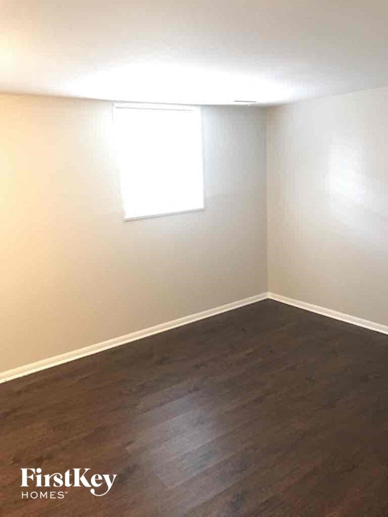 a empty room with wooden floors and a window