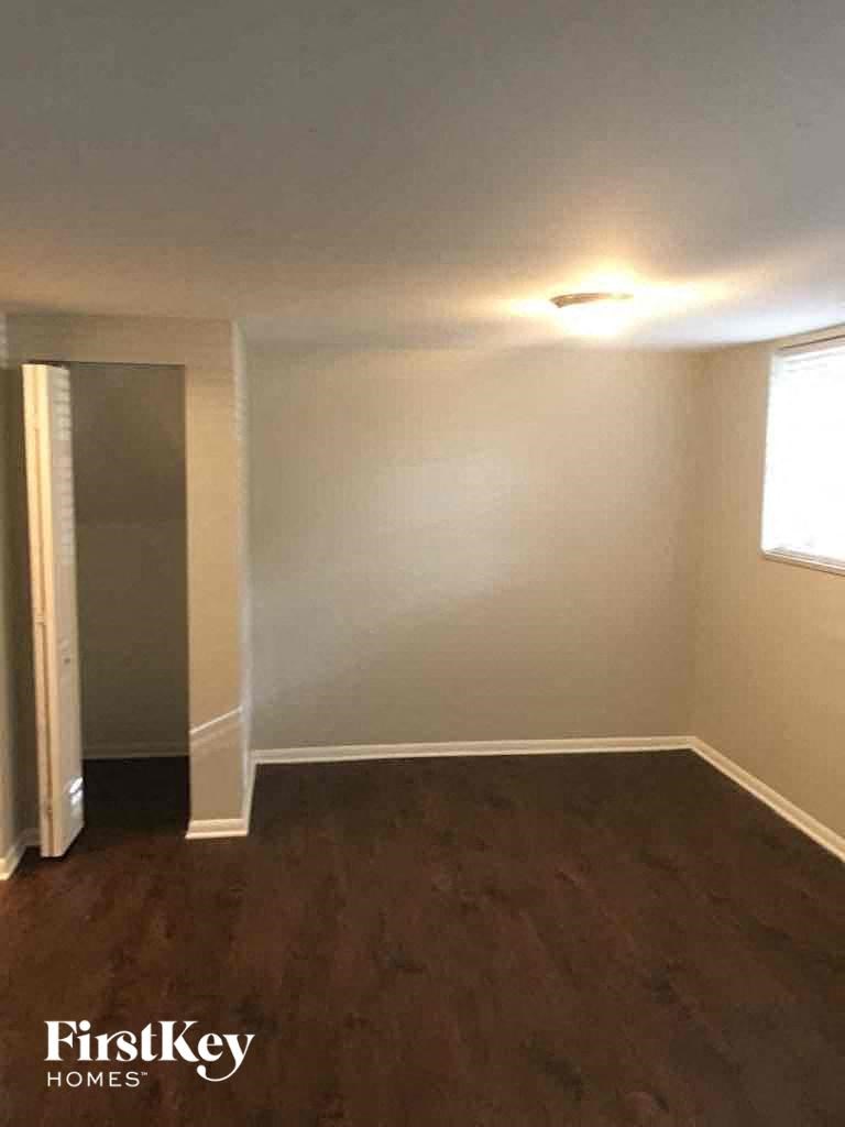an empty room with white walls and a wooden floor