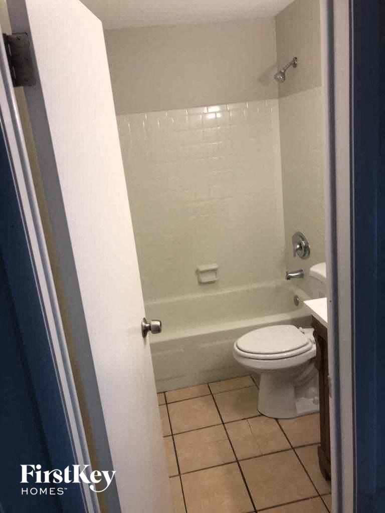 a small bathroom with a toilet and a bath tub