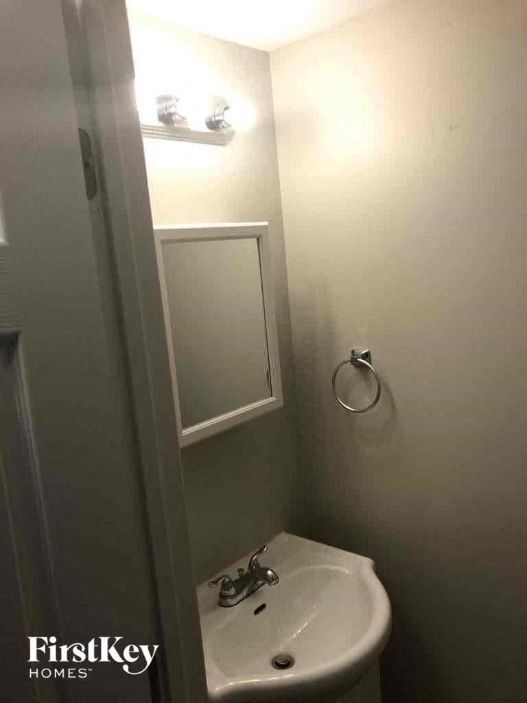 a small bathroom with a sink and a mirror