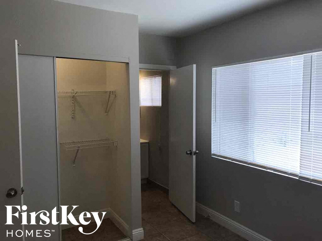a small bathroom with a shower and a closet
