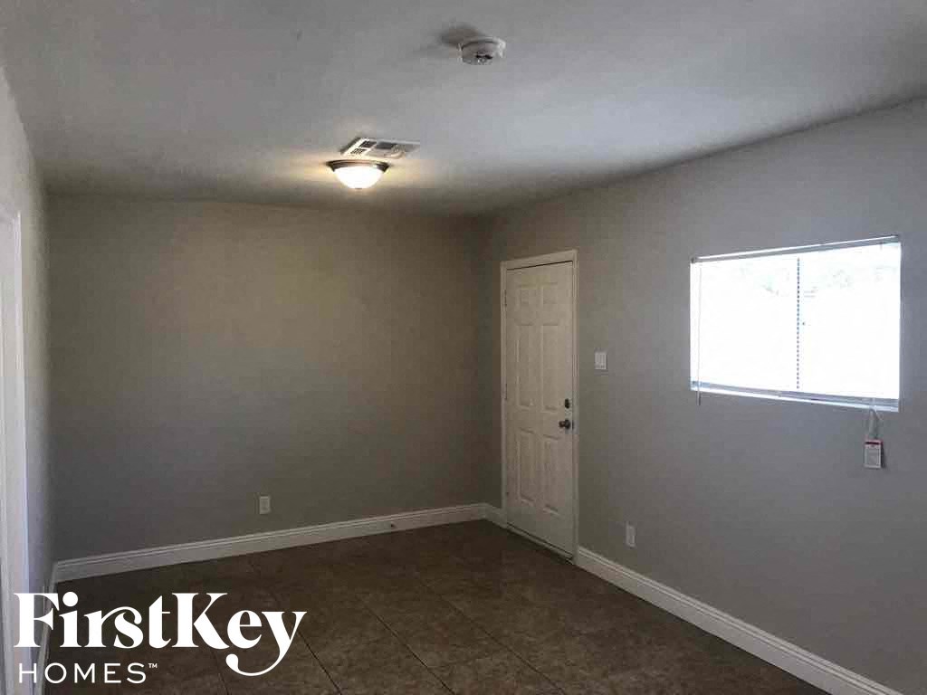 a room with gray walls and a white door
