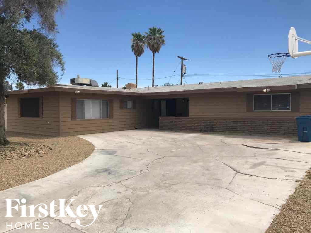 a house with a basketball hoop in the driveway
