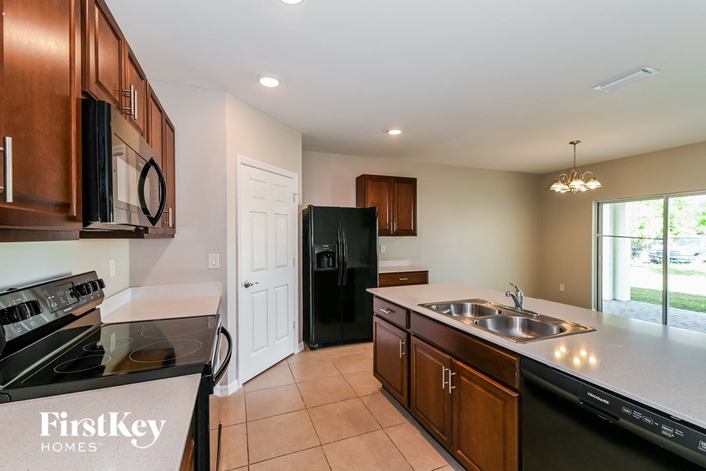 a kitchen with black appliances and white counter tops