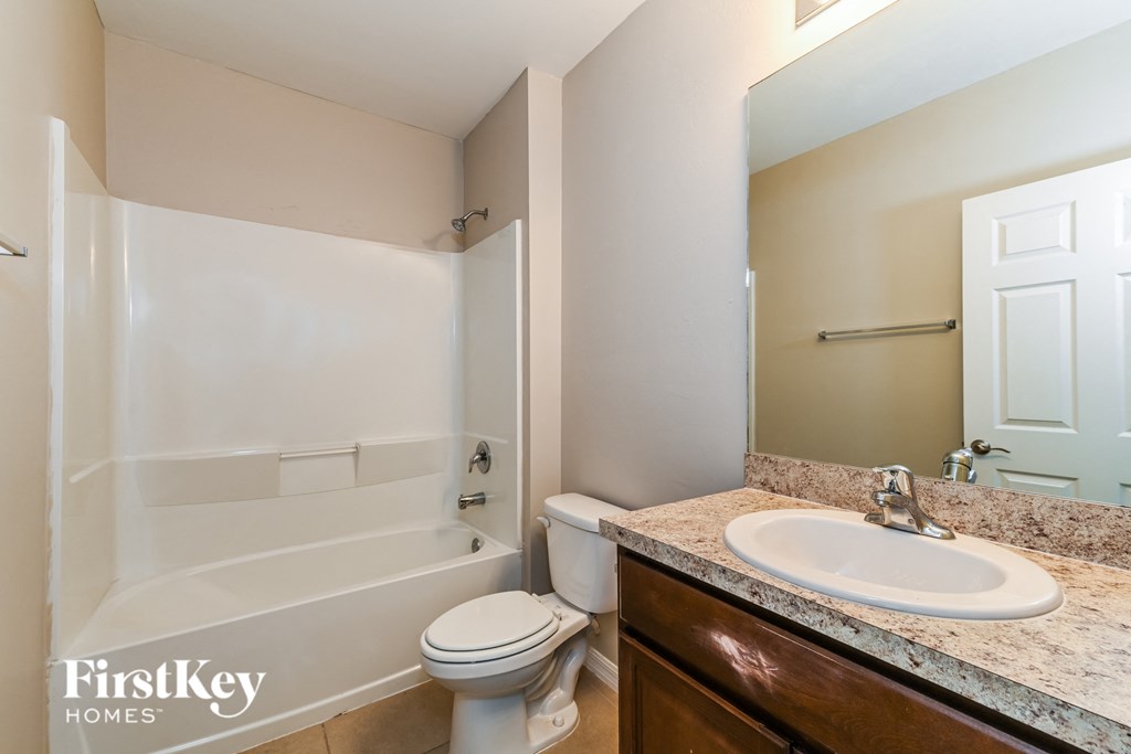 a bathroom with a sink toilet and a bath tub