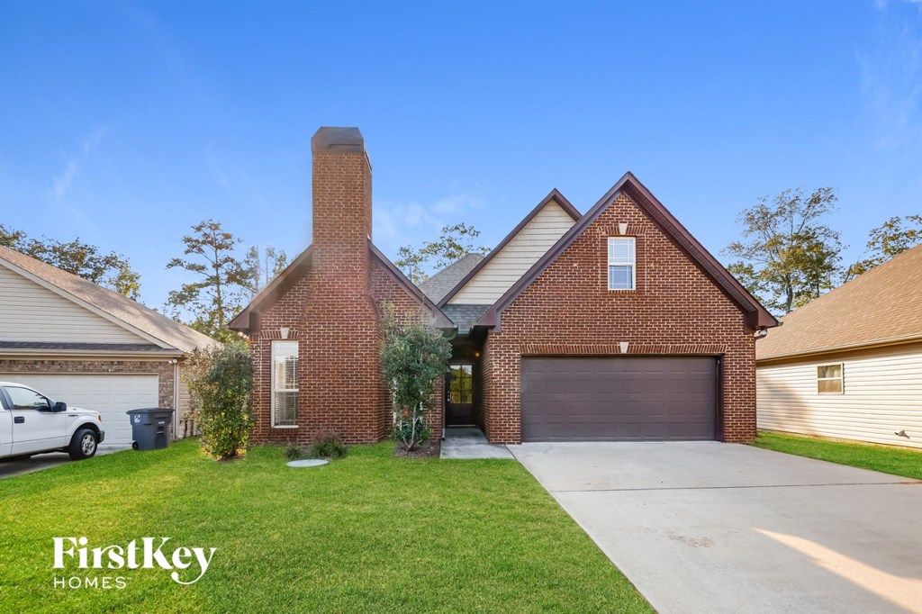 A house with a garage and a chimney is for sale.