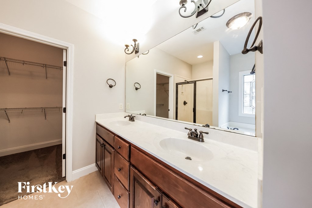 A bathroom with a double sink and a large mirror.