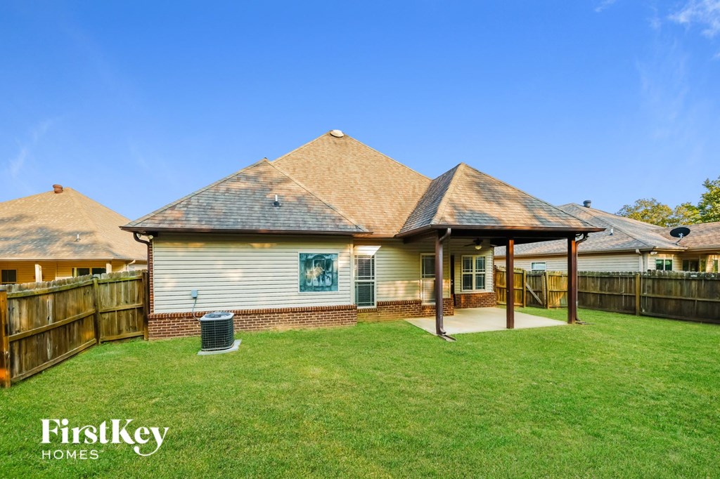 A house with a brown roof and a white wall with a window and a door.