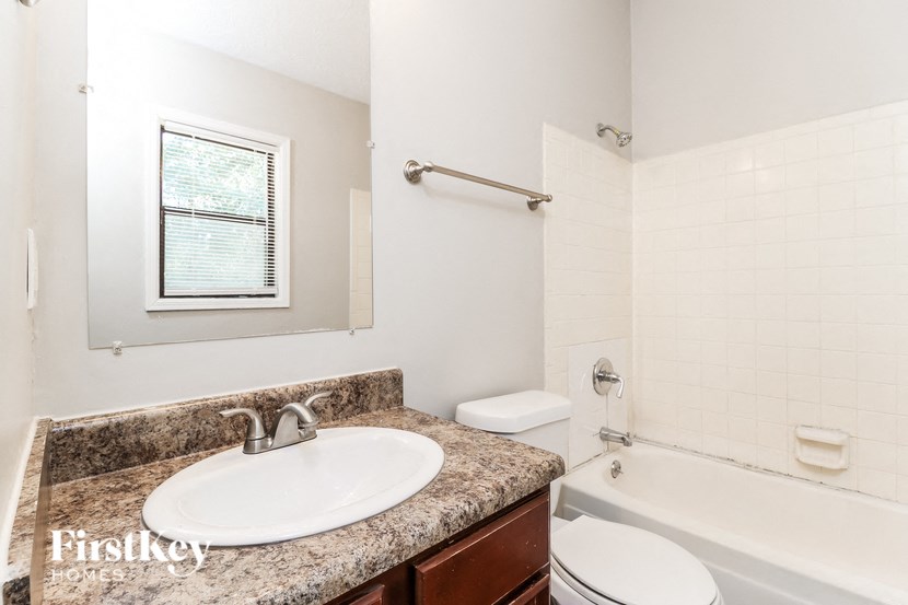 a bathroom with a sink toilet and a bath tub