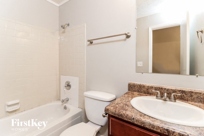 a white bathroom with a sink toilet and bath tub