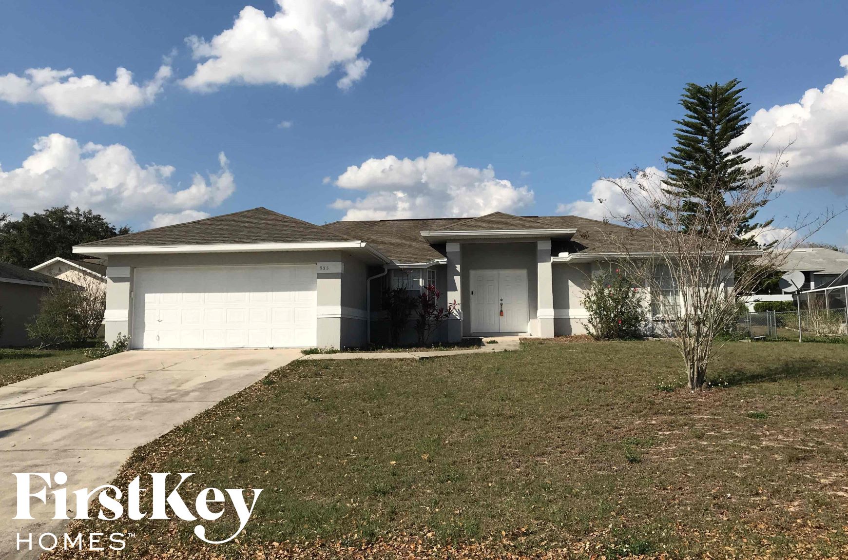 a house with a lawn and a garage