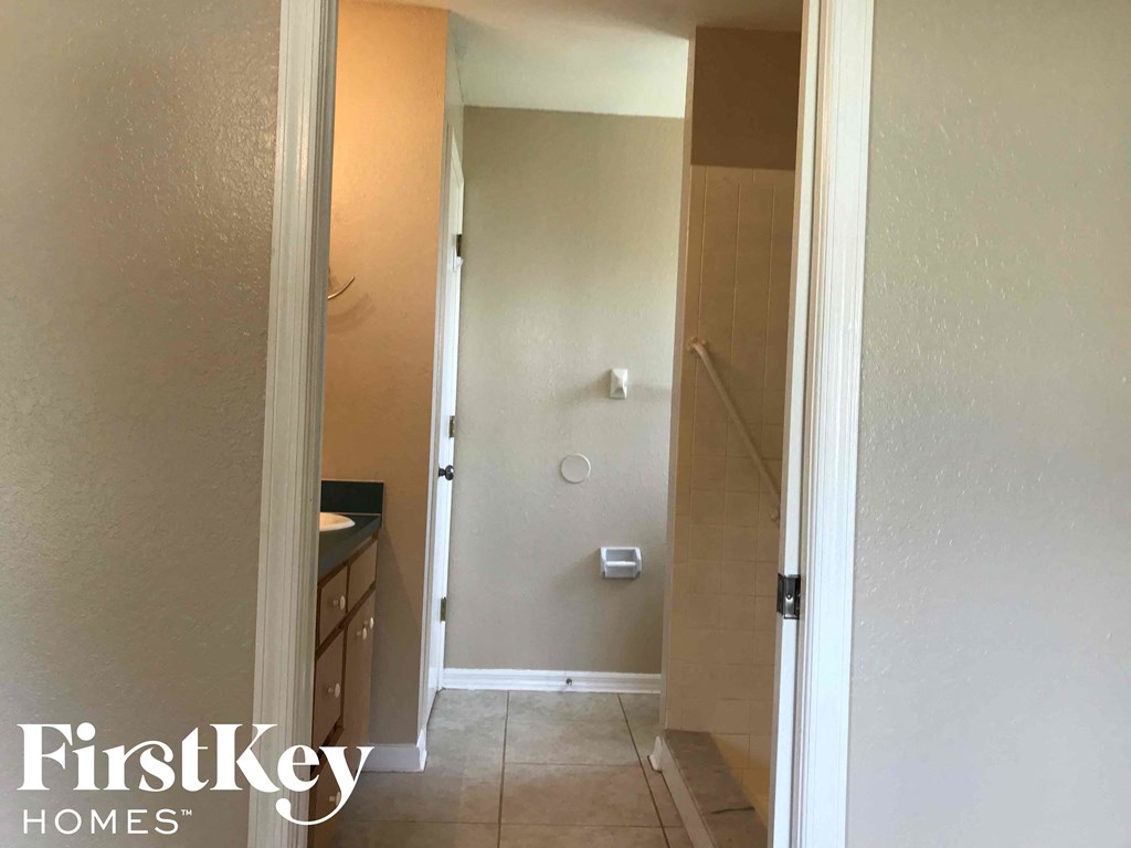 a small bathroom with a shower and a sink in it