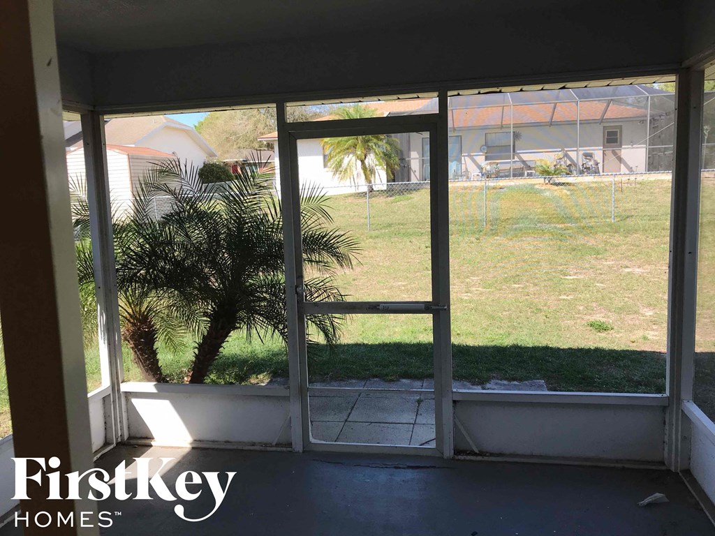 the view from the living room into the screened in porch
