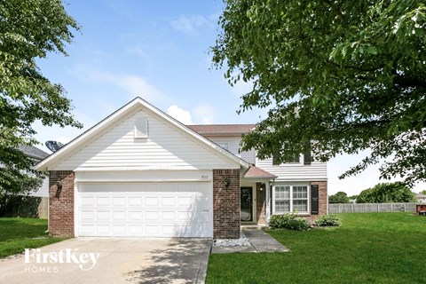a white garage door in front of a white house