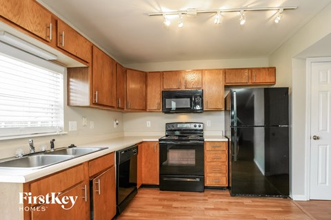 a kitchen with black appliances and wooden cabinets
