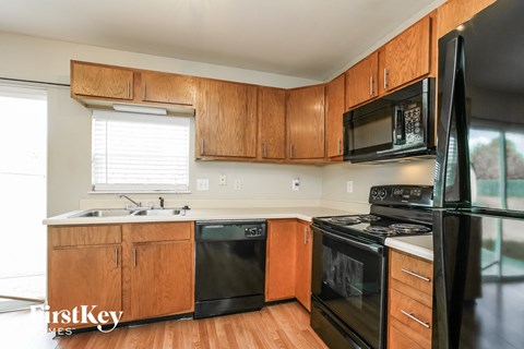 a kitchen with black appliances and wooden cabinets