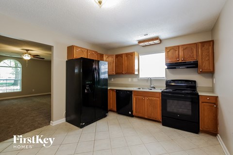 a kitchen with black appliances and wooden cabinets