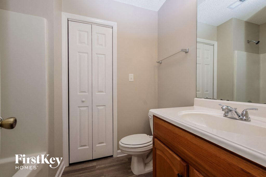 a bathroom with a toilet and a sink and a mirror
