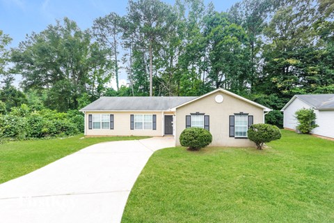 a white house with a yard and a sidewalk