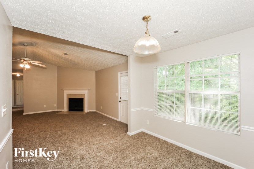 a living room with a fireplace and a large window