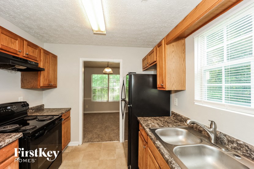 a kitchen with a sink and a refrigerator