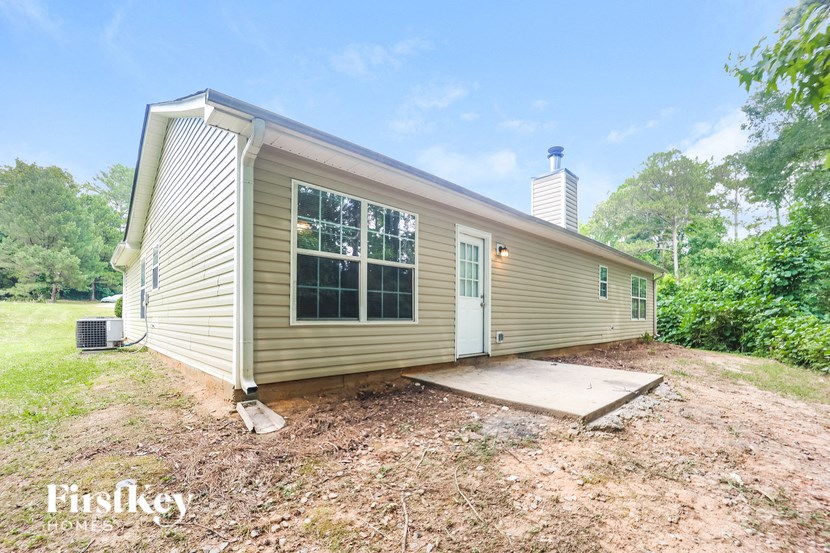 the exterior of a tiny house in the woods