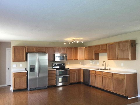 A kitchen with wooden cabinets and stainless steel appliances.