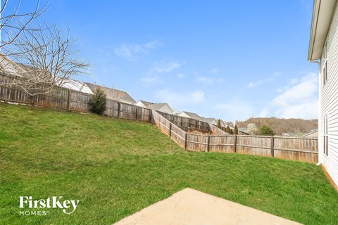 a fisheye view of a fenced in backyard with green grass