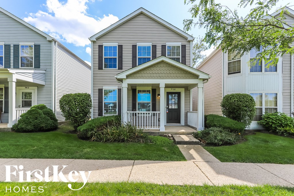 a white house with a sidewalk in front of it