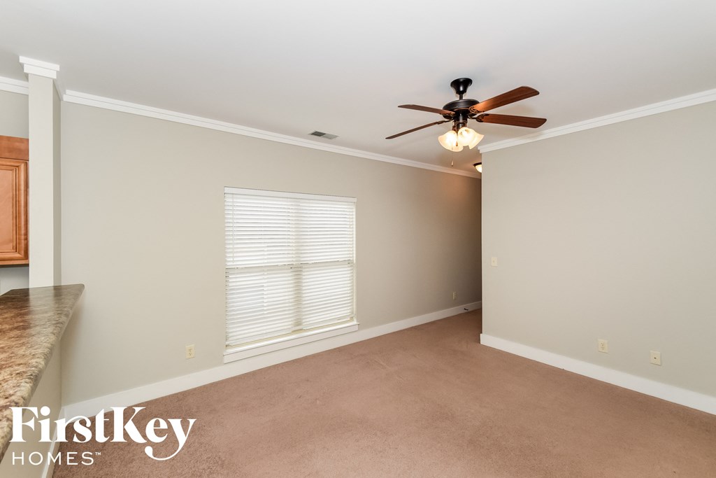 a dining room with a ceiling fan and a window