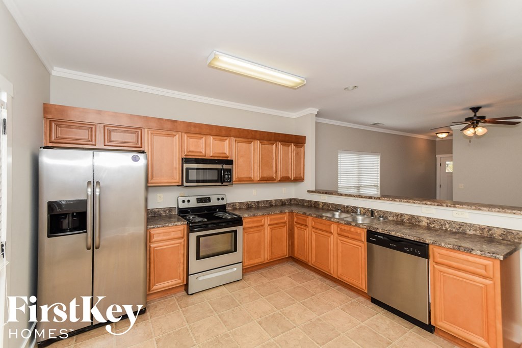 a kitchen with stainless steel appliances and wooden cabinets