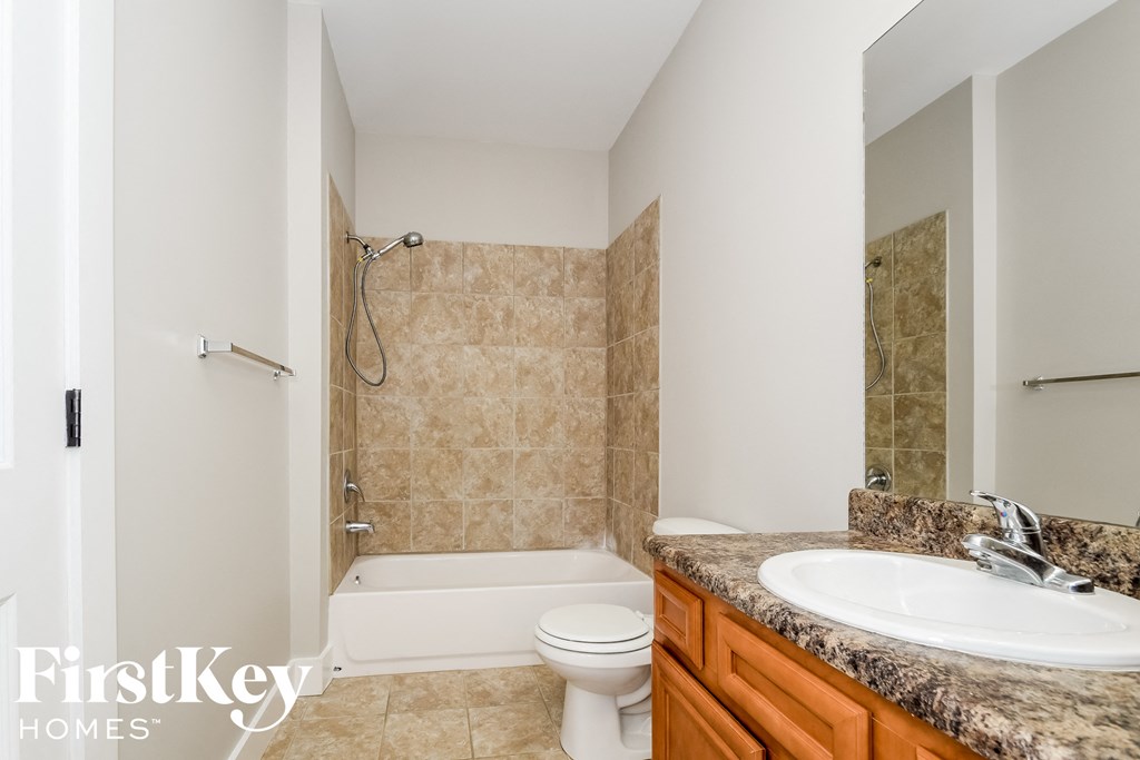 a bathroom with a sink and a toilet and a bath tub