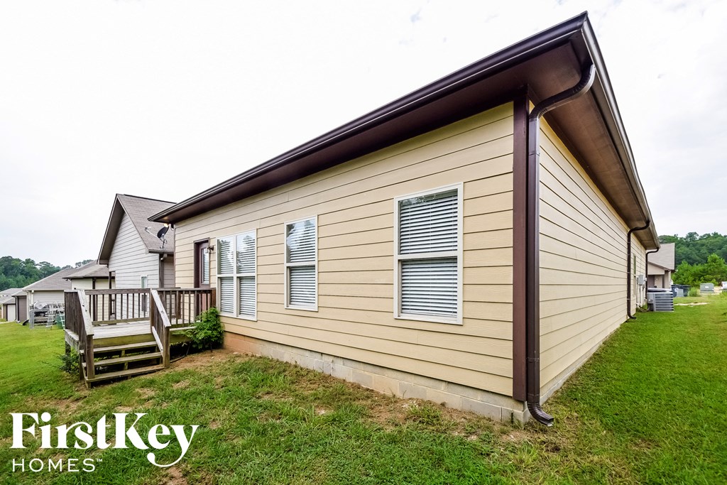 a view of the side of a house with a deck