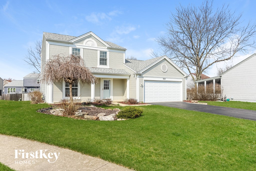 a white house with a lawn in front of it