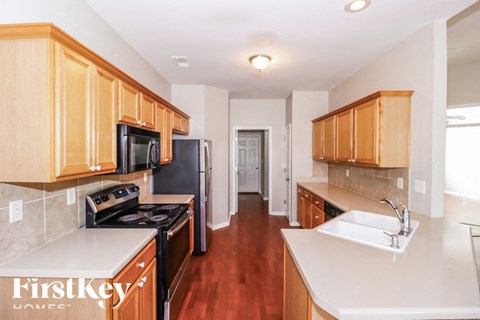 A kitchen with wooden cabinets and a white counter top.