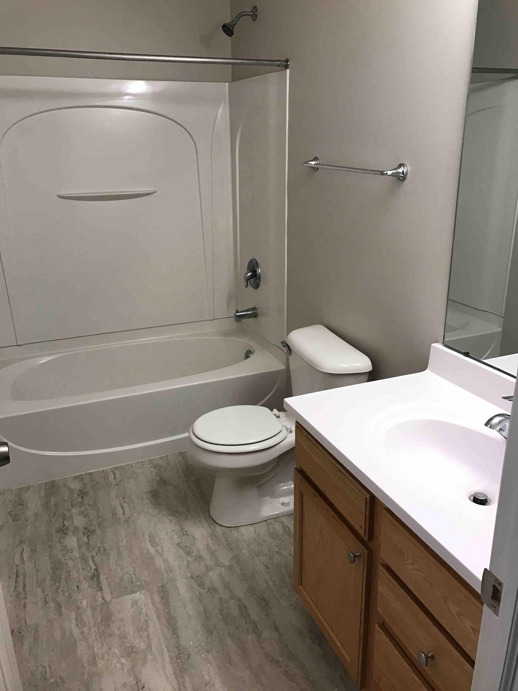 a bathroom with a toilet and a sink and a shower