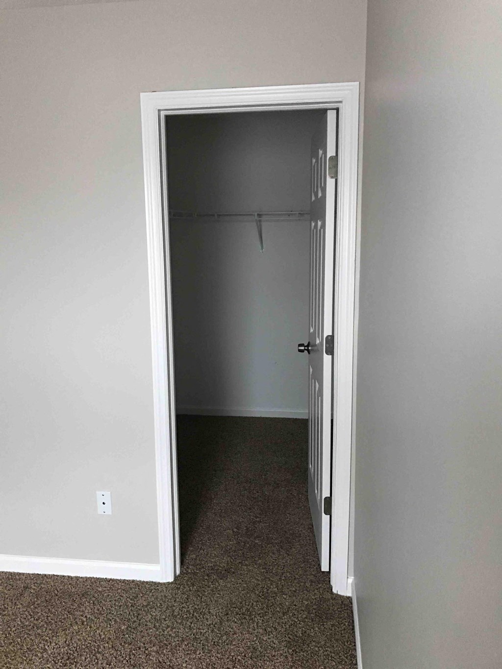 a room with a closet and a door open