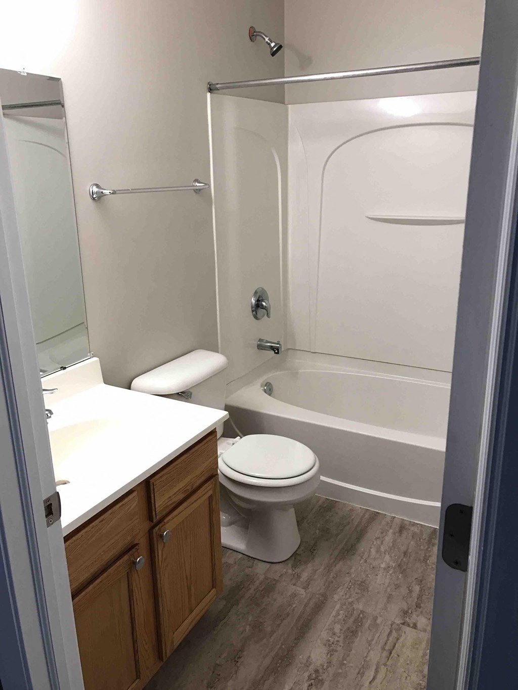 a bathroom with a toilet and a tub and a sink