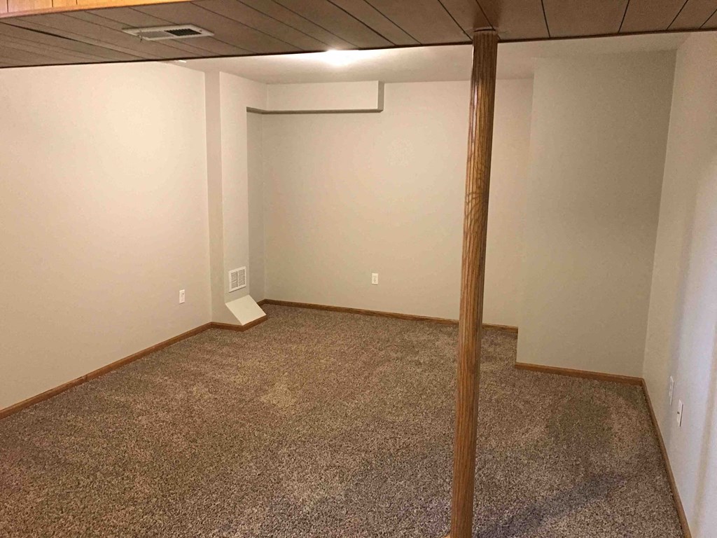 a room with a carpeted floor and white walls
