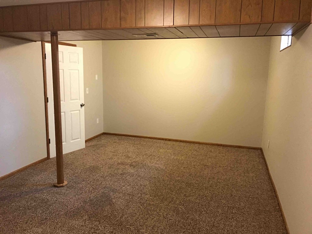 a room with a carpeted floor and a door