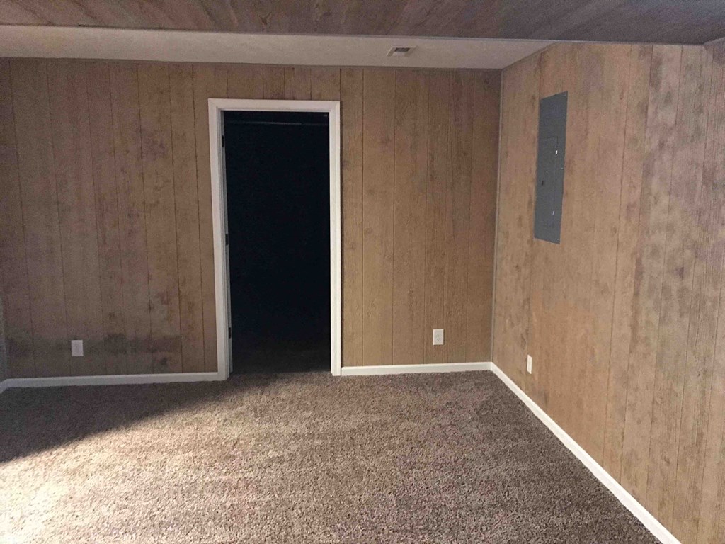 an empty room with carpet and a door