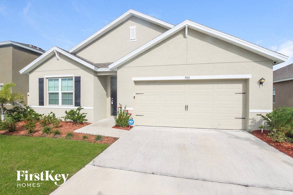 a home with a white garage door and a driveway