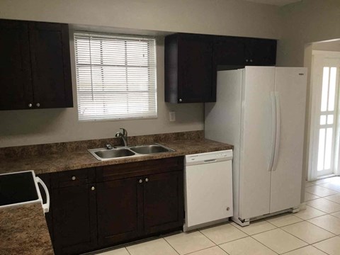a kitchen with a sink and a refrigerator