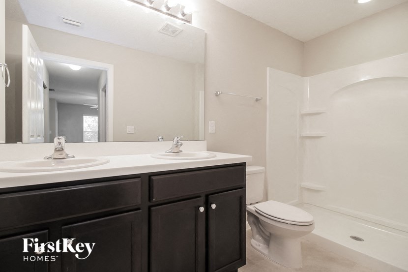 a bathroom with a toilet and a sink and a mirror