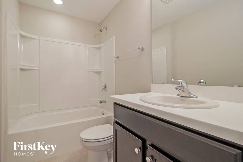a white bathroom with a sink and a toilet