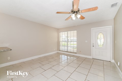 A room with a fan and a door.